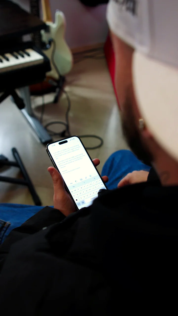 Un artista repasando la letra en el móvil dentro del estudio